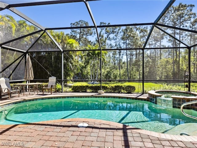 13117 Cardeto Ct, Estero, FL 33928 - view of pool featuring a lanai, a pool with connected hot tub, and a patio