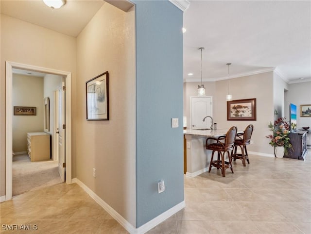 13117 Cardeto Ct, Estero, FL 33928 - hallway featuring light tile patterned floors, crown molding, and baseboards