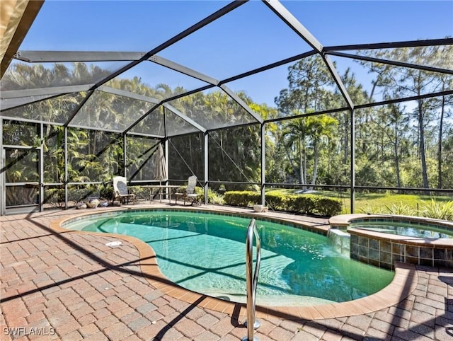 13117 Cardeto Ct, Estero, FL 33928 - view of swimming pool with glass enclosure, a pool with connected hot tub, and a patio