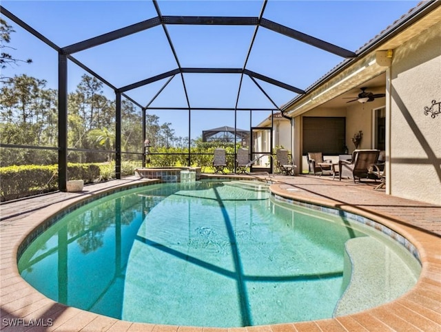13117 Cardeto Ct, Estero, FL 33928 - outdoor pool featuring glass enclosure, a patio, and a ceiling fan