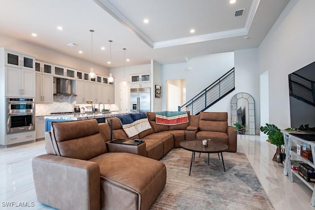 living area featuring recessed lighting, visible vents, a raised ceiling, and crown molding