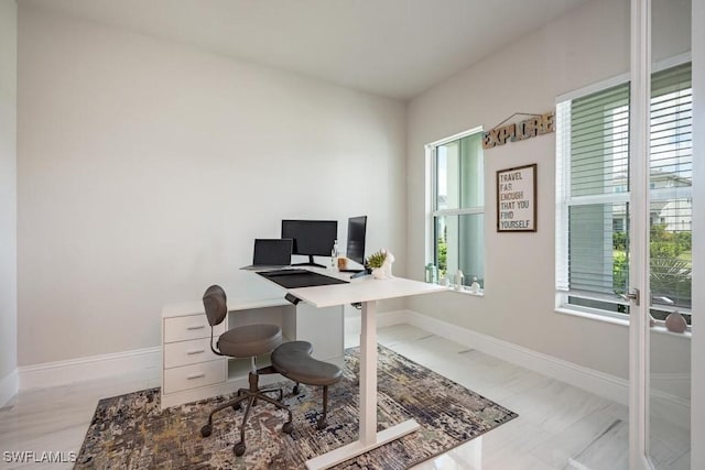 office featuring a healthy amount of sunlight and baseboards