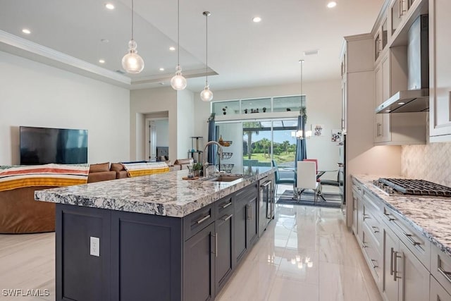 9121 Caicos Way, Naples, FL 34114 - kitchen with a sink, stainless steel gas stovetop, backsplash, wall chimney range hood, and recessed lighting