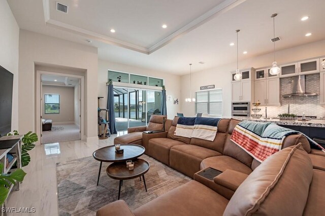 9121 Caicos Way, Naples, FL 34114 - living room with recessed lighting, marble tiled flooring, healthy amount of natural light, a raised ceiling, and crown molding