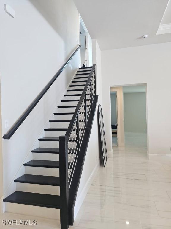 9121 Caicos Way, Naples, FL 34114 - stairway featuring marble finish flooring and baseboards