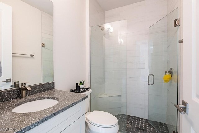 9121 Caicos Way, Naples, FL 34114 - full bathroom featuring a shower stall, toilet, and vanity