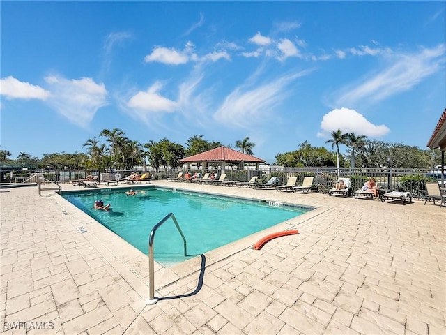 community pool featuring a patio and fence