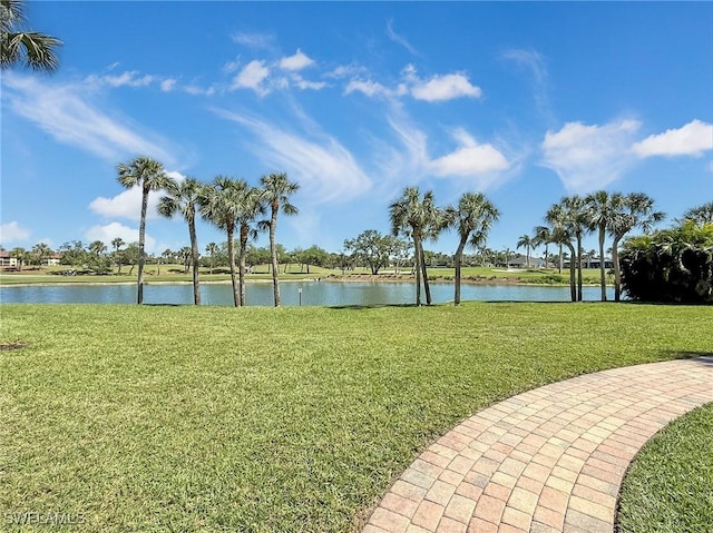 view of community with a lawn and a water view