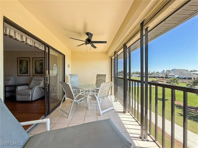 sunroom / solarium featuring ceiling fan