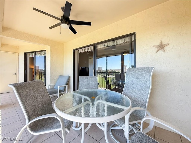 view of patio / terrace with outdoor dining area, a balcony, and ceiling fan