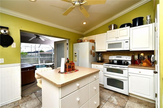 kitchen featuring white appliances, lofted ceiling, ceiling fan, and crown molding