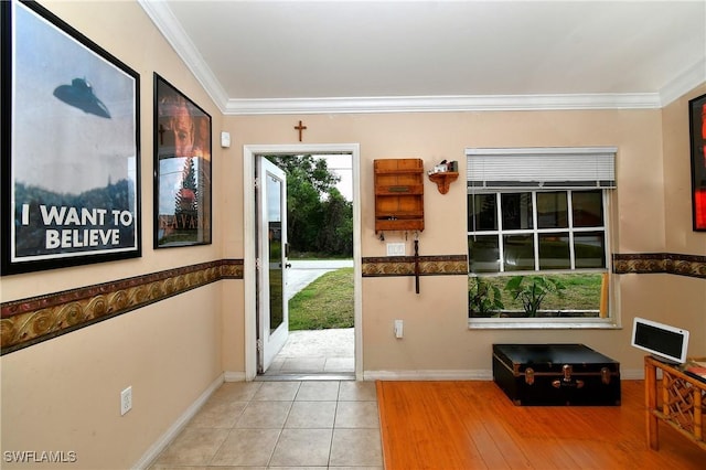 entrance foyer with tile patterned flooring, baseboards, and ornamental molding