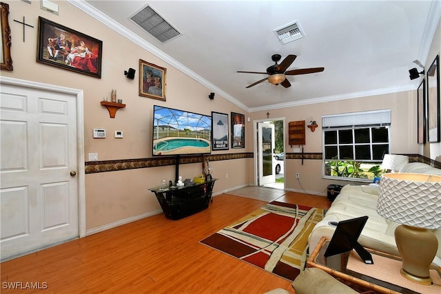living room featuring crown molding, wood finished floors, a ceiling fan, and visible vents