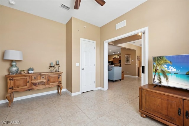 interior space with light tile patterned flooring, a ceiling fan, and visible vents