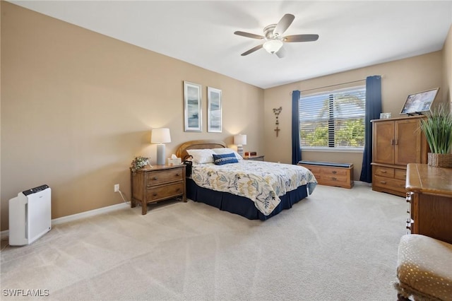 bedroom featuring light colored carpet, baseboards, and ceiling fan