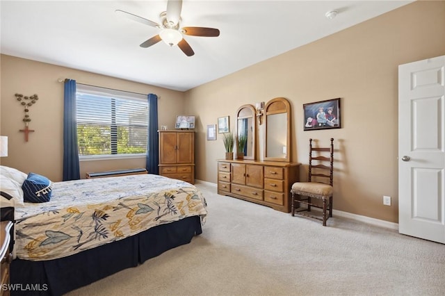 carpeted bedroom featuring baseboards and ceiling fan