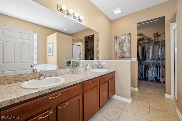 full bath with a sink, double vanity, a stall shower, and tile patterned floors