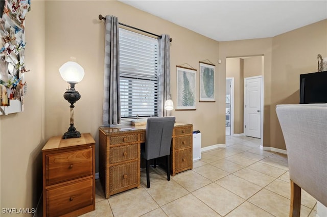 office featuring light tile patterned floors and baseboards