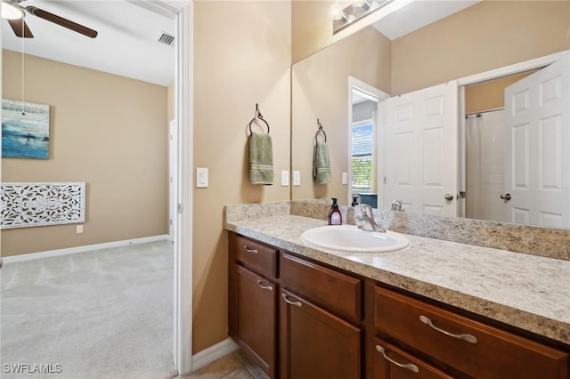 bathroom featuring baseboards, vanity, and a ceiling fan