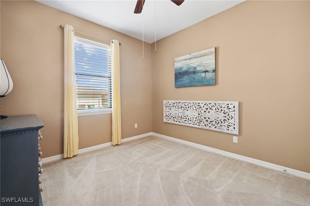 empty room with baseboards, a ceiling fan, and carpet floors