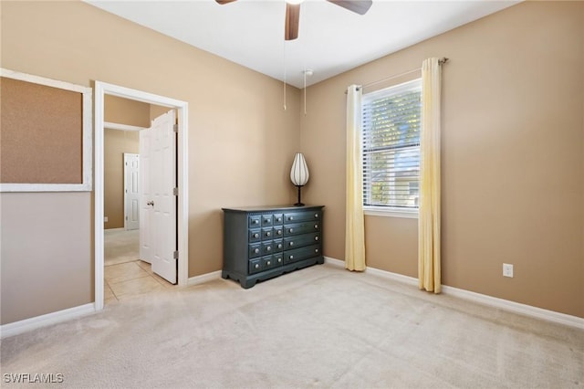 unfurnished bedroom with a ceiling fan, baseboards, and carpet floors