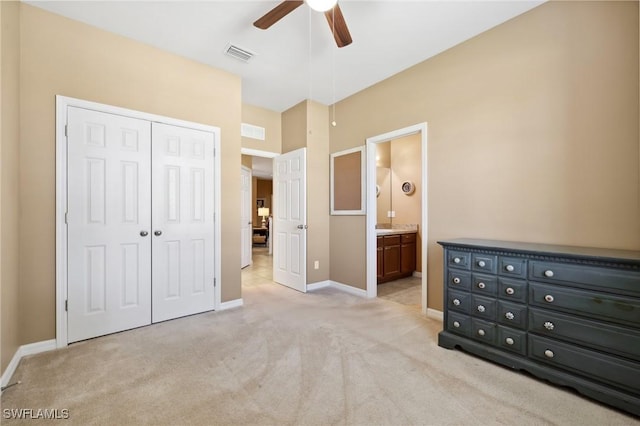 unfurnished bedroom featuring visible vents, a closet, connected bathroom, baseboards, and light colored carpet