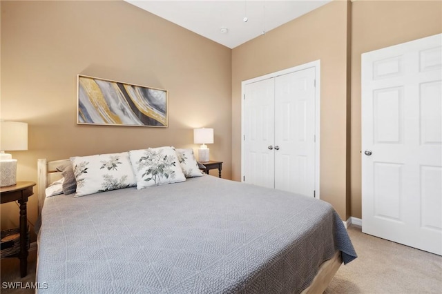 carpeted bedroom with baseboards and a closet