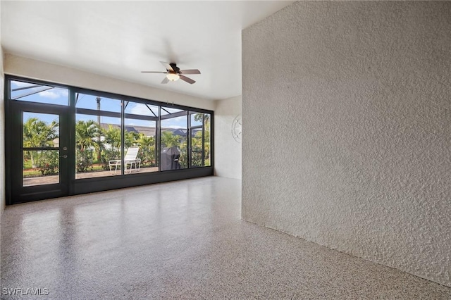 empty room with speckled floor and ceiling fan