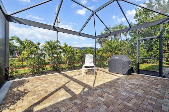 view of patio with a grill and a lanai