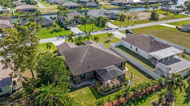 drone / aerial view with a residential view and a water view