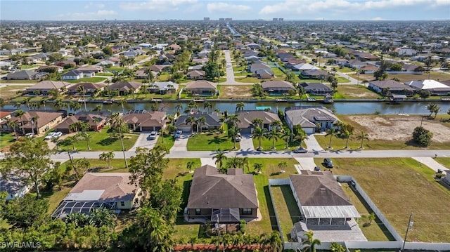 drone / aerial view featuring a residential view and a water view