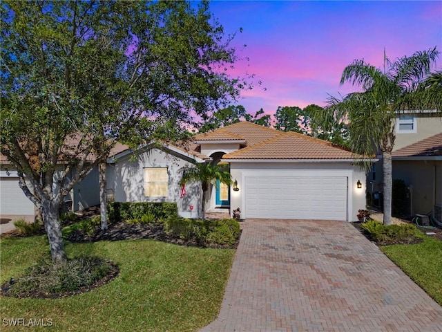 21116 Bella Terra Blvd, Estero, FL 33928 - view of front of property with stucco siding, decorative driveway, a garage, and a tiled roof