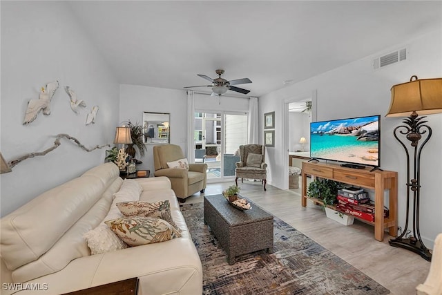 living area featuring a ceiling fan, visible vents, and light wood-type flooring