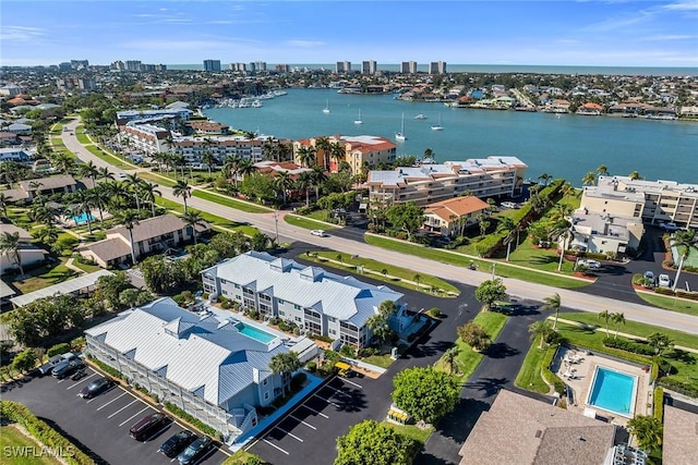 drone / aerial view featuring a water view and a view of city