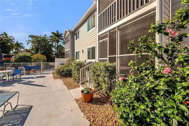 exterior space featuring outdoor dining space and fence