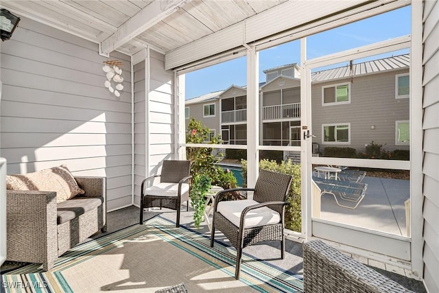 sunroom featuring beamed ceiling and wood ceiling