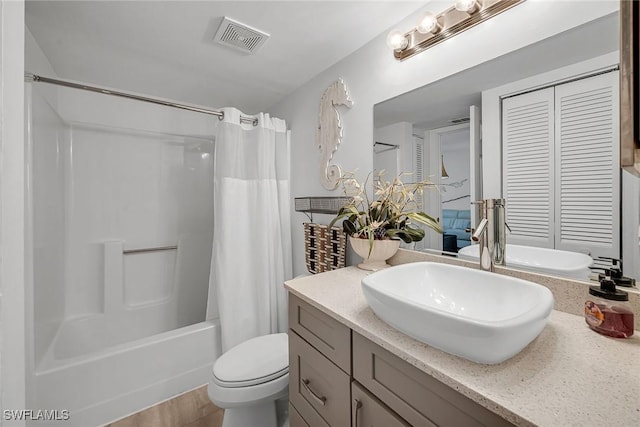 full bathroom with vanity, shower / bath combo with shower curtain, toilet, and visible vents