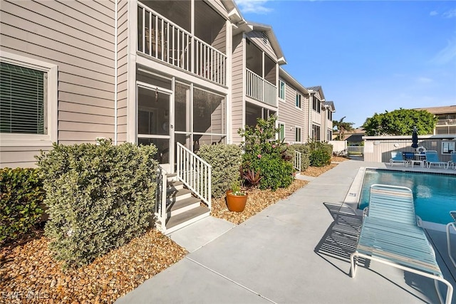 view of swimming pool with a patio area, a fenced in pool, and a residential view