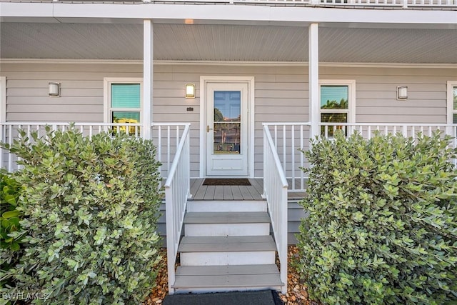 view of exterior entry with covered porch