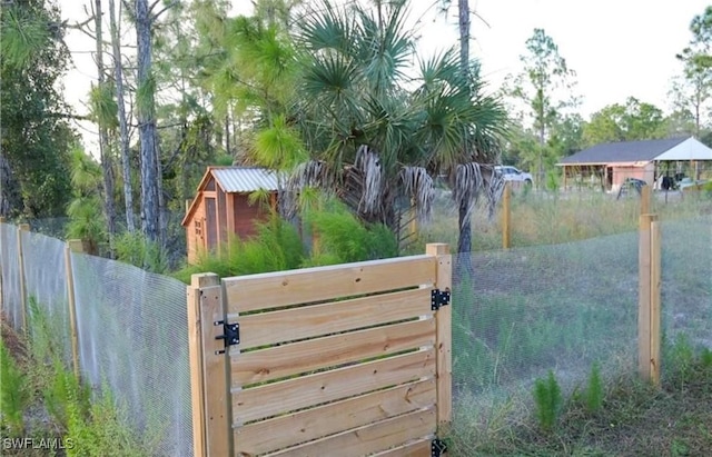 view of gate with fence