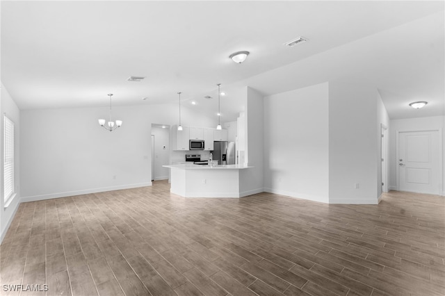 unfurnished living room featuring visible vents, baseboards, lofted ceiling, light wood-style flooring, and an inviting chandelier