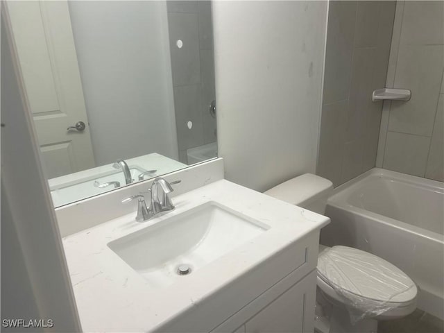 bathroom featuring toilet, vanity, and bathtub / shower combination