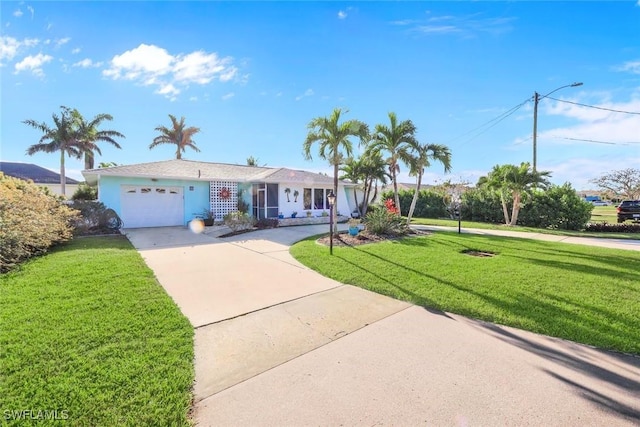 single story home with a front lawn, an attached garage, and driveway