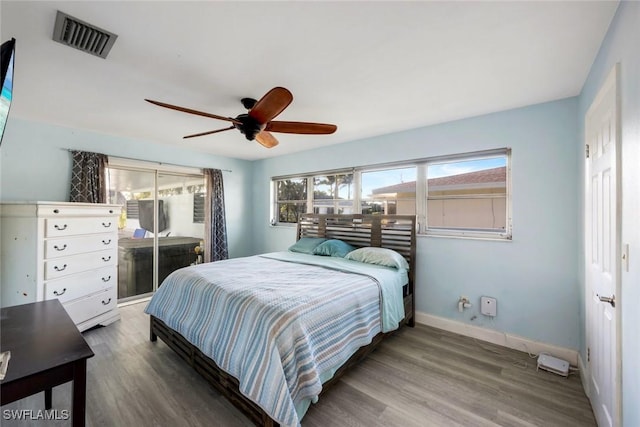 bedroom with visible vents, a ceiling fan, access to outside, wood finished floors, and baseboards