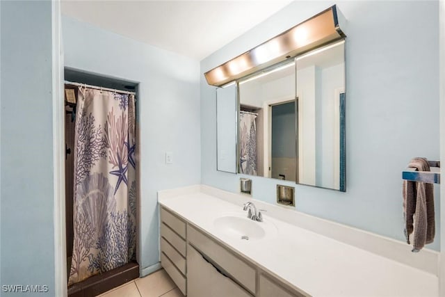 full bathroom featuring tile patterned floors, a shower with curtain, and vanity