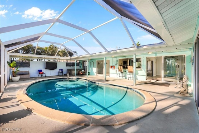 outdoor pool featuring a patio area and a lanai