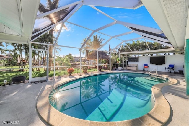 outdoor pool with a lanai and a patio area