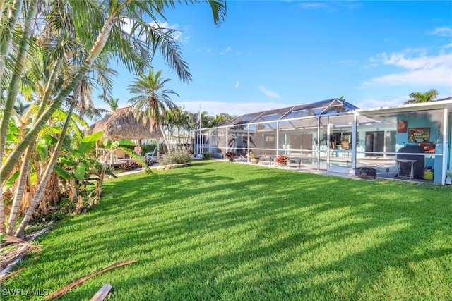 view of yard with an outdoor pool and a lanai