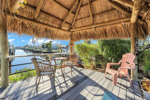 deck with a gazebo and a water view