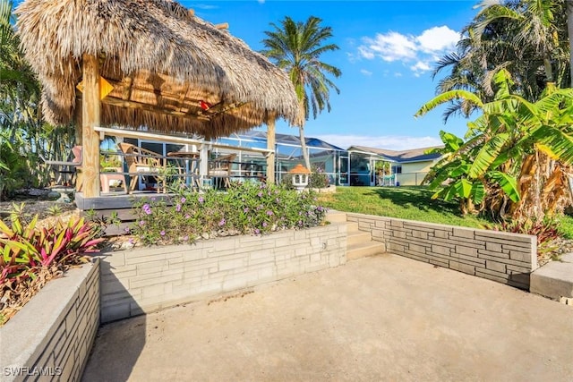 view of patio featuring a lanai